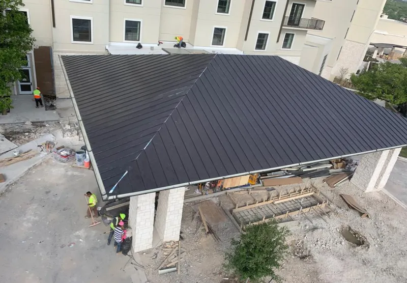 Metal roofing installation team working on a commercial building in Upper Saucon